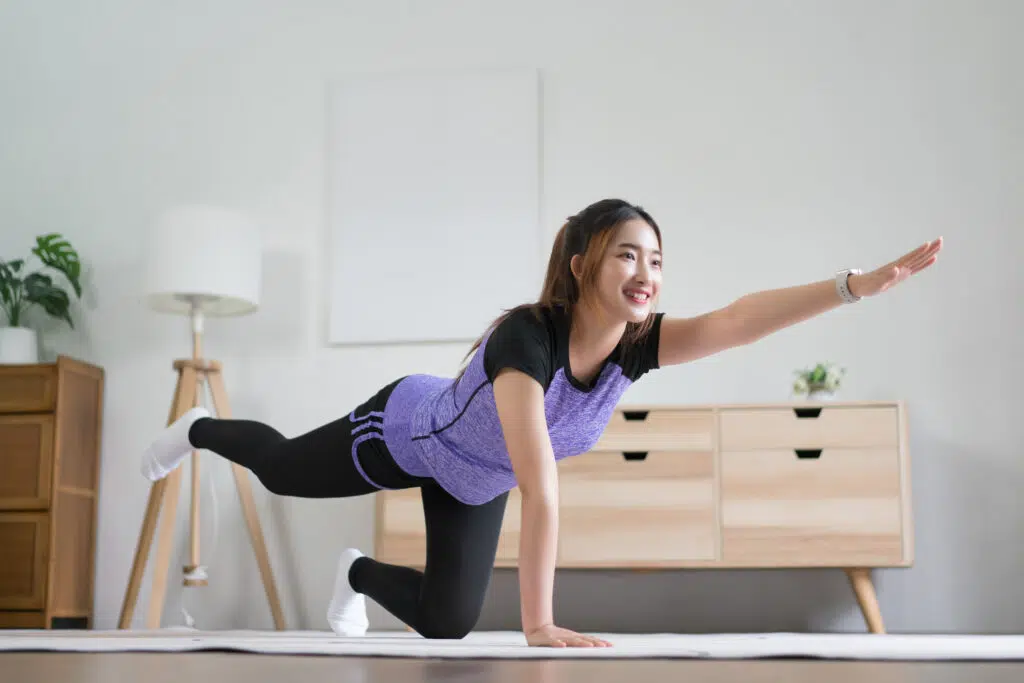 Young asian woman doing yoga balance exercise with bird dog pose | Physiotherapy First